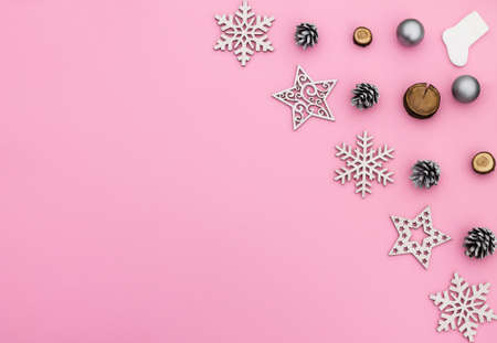 Christmas and New Year. Pink flat lay frame with snowflakes, Christmas toys and cones. Copy spaceの写真素材
