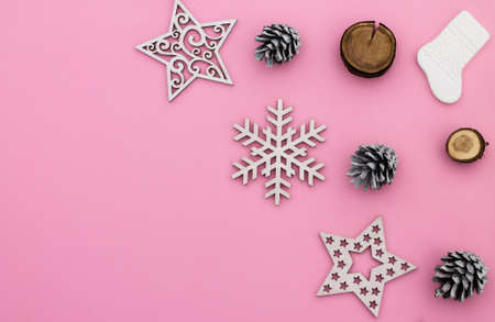 Christmas and New Year. Pink flat lay frame with snowflakes, Christmas toys and cones. Copy spaceの写真素材