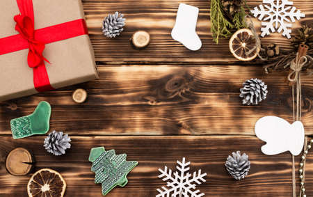 Christmas and New Year. Wooden dark flat lay frame with gifts, Christmas toys and cones. Copy spaceの写真素材