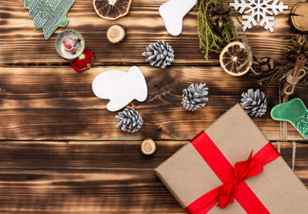 Christmas and New Year. Wooden dark flat lay frame with gifts, Christmas toys and cones. Copy spaceの写真素材