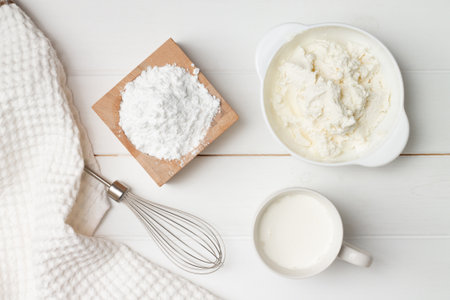 Step-by-step heart-shaped cake recipe instructions. Step 6, ingredients for the cream. Powdered sugar, ricotta, whipping cream. Flat lay.の写真素材