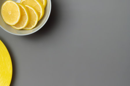 Yellow lemons in gray plate on gray background. Colors of the Year 2021  Illuminating and Ultimate gray. Flat lay. Copy spaceの写真素材