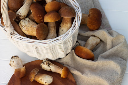 White wicker basket with brown boletus mushrooms.の写真素材