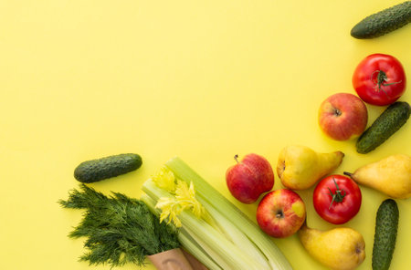 Fresh organic vegetables, greens and fruits on a yellow background. Ecological farm food concept. Top view. Flat layの写真素材