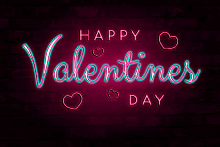 Neon glowing pink and blue Happy Valentines Day lettering on brick wall backgroundの写真素材