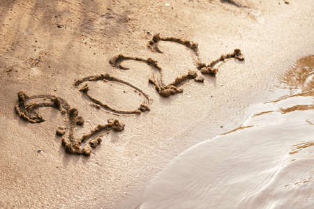Number 2022 drawn on wet sand on coast. Merry Christmas and Happy New Year concept