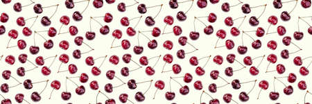 Seamless endless pattern of bright ripe red sweet cherries isolated on white backgroundの写真素材