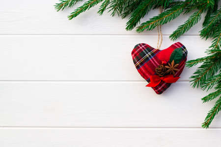 Green branches of a Christmas tree with DIY soft decoration on a background of white boards. Flat lay, copy space.の写真素材