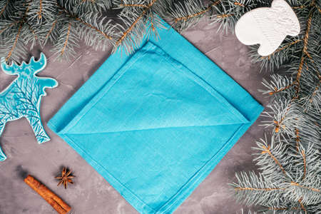 Step-by-step tutorial: Fold linen napkin in shape of Christmas tree. New Year table setting. Step 2: Take first layer of fabric at bottom corner and set aside, just short of edge of napkin. Top viewの写真素材