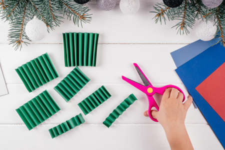 Step-by-step Greeting card 3D Christmas tree tutorial. Step 11: Cut folded sheet along marks. Top viewの写真素材