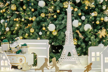 White silhouettes of Eiffel Tower and houses against background of decorated Christmas treeの写真素材
