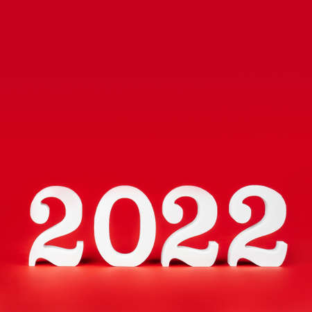 Happy New Year 2022. Bright red square banner with white wooden numbers 2022 stand at bottom. Merry Christmas. Copy space. Place for textの写真素材