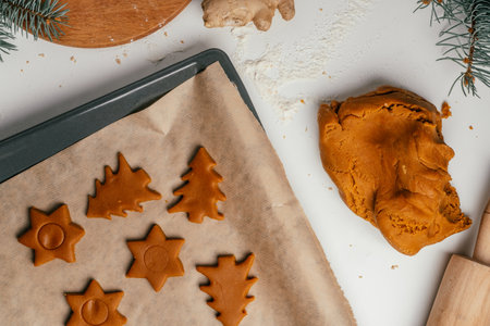 Step-by-step tutorial on baking Christmas gingerbread cookies. Step 12: Cut out cookies with cookie...
