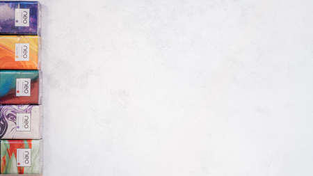 Packs of Neo smoking sticks with different flavors on white concrete surface. Cigarettes for use with Glo heating device. Copy space. Flat lay. Top view. Minsk, Belarus 30.10.2021のeditorial素材