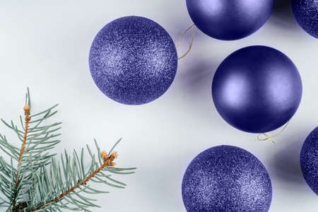 Color of the Year 2022 Very Peri. Trendy background of Christmas shiny balls with christmas tree brunch. Fashion purple shade. Copy spaceの写真素材