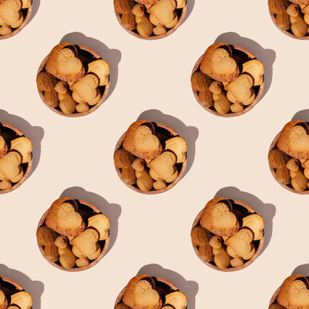 Seamless endless pattern of heart shaped gingerbread cookies in wooden bowl with hard shadows isolated on light pink background. Top viewの写真素材