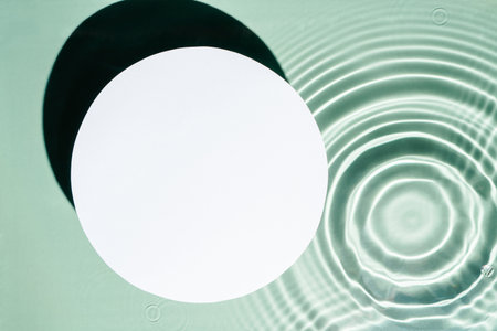 White circle copy space in transparent fresh green blue water drop splashing gel surface with...