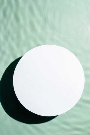 White circle copy space in transparent fresh green blue water drop splashing gel surface with...