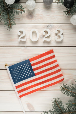 National american flag on table, top view. Frame from organic spruce branches and christmas tree...