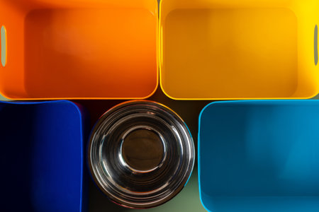 Multicolored plastic and metal containers on green background. Plastic free, sort of waste and garbage. Ecological lifestyle, responsibility, sustainability. Blank and template. top view, full frameの写真素材