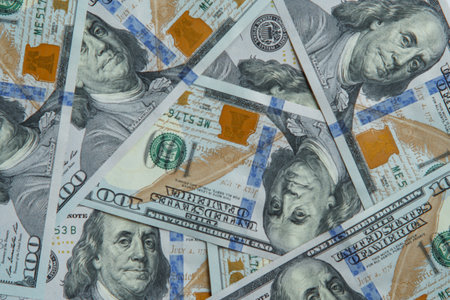 Close-up of heap of one hundred 100 dollars banknotes bills. Paper banknote, money, cash, currency, savings, finance, banking payment, salary, texture, monetary fund, business. Flat lay, top view.の写真素材