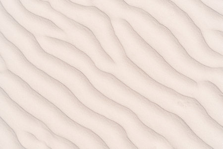 Textured beige sand with veins as sign of hot summer vacation, Top view, full frame. Background and...