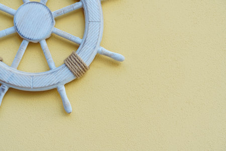 Vacation on yacht. White marine steering wheel on light background. Sea voyages and adventures....
