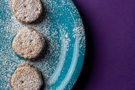 Coconut cookies on a blue plate on a purple background.の写真素材