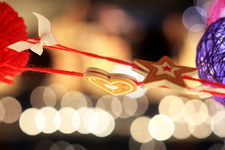 suspended on thread colored heart and star hanging on the Christmas tree