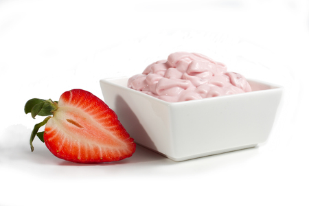 Strawberry cheese in a white porcelain bowl decorated with fresh strawberry halvesの写真素材