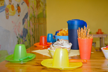 Table with colorful cups and saucers prepared to accept the name day or birthday toddlerの写真素材