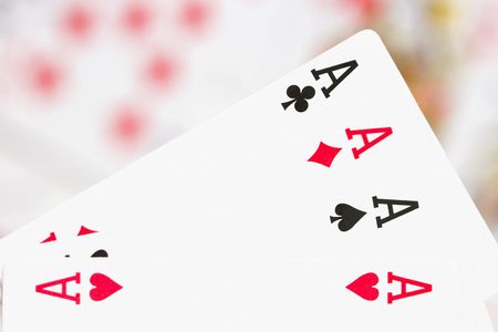 four aces against scattered, blurred cardsの写真素材