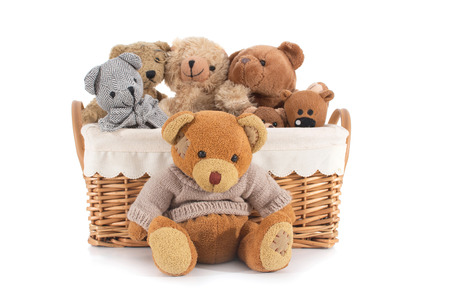 Teddy bears in a straw basket on a white backgroundの写真素材