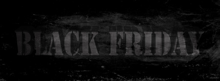 Black Friday lettering in the shape of an unevenly reflected three-dimensional stamp on a black, scratched backgroundの写真素材