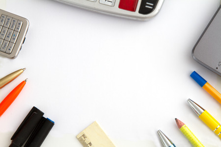 concept - a desk to work with a calculator, a mobile phone, a pen and stationeryの写真素材