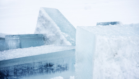 ice blocks cut from the lake lying in the snowの写真素材