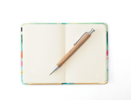 Decorative diary with a wooden pen lying on itの写真素材