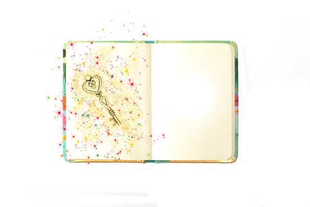 Diary with a decorative brass key with a heart and scattered starsの写真素材