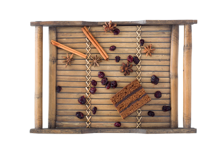 Gingerbread dough - a composition with cinnamon, cloves and raisins on a wooden trayの写真素材