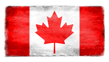 Canadianflag with traces of use in battle and destruction from difficult warfareの写真素材