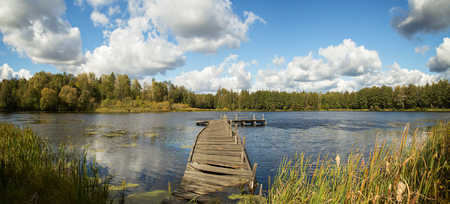 Landscape with lake, landing and blue sky with white clouds - panoramaの写真素材