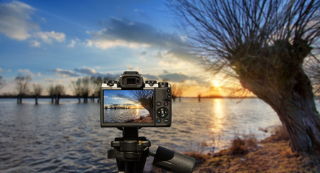 Camera and High water on the Polish river Bug before sunset in early spring