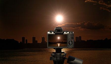 Camera and Warsaw in the rays of the morning sun - view from the Vistula.
