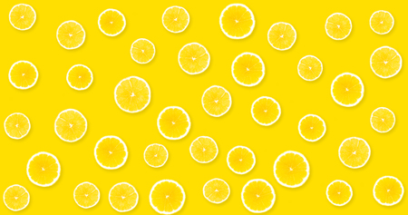 Background with yellow lemons from which you can see a yellow, uniform backgroundの写真素材