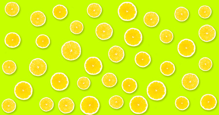 Background with yellow lemons from under which you can see in lime color, uniform backgroundの写真素材