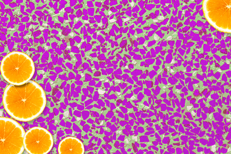 Slices of orange lying on a colored backgroundの写真素材