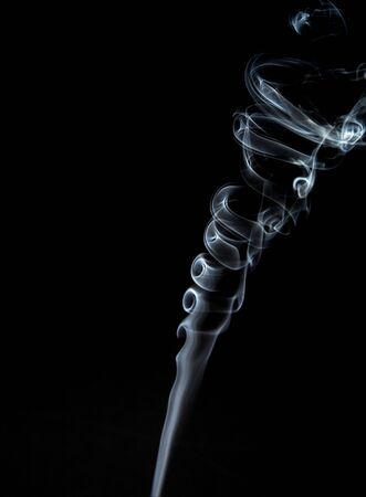 Gray, twisted smoke on a black backgroundの写真素材