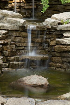 A small cascade of water, a waterfall in the garden.の写真素材
