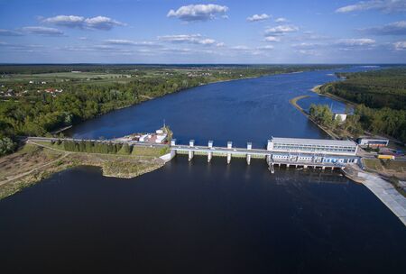 The dam and hydroelectric power station on ZegrzyÅski Lake from the bird's eye view with a nice sky with cloudsの写真素材
