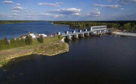 The dam and hydroelectric power station on ZegrzyÅski Lake from the bird's eye view with a nice sky with cloudsの写真素材
